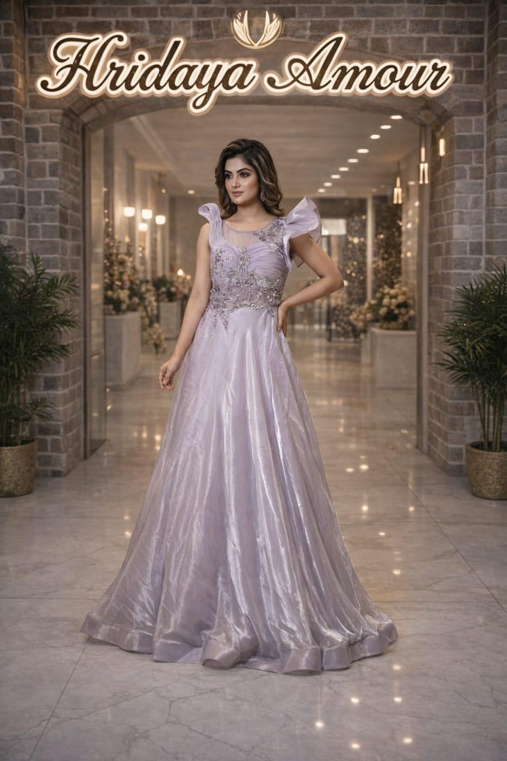 Model in a lilac embellished evening gown with sculpted shoulder detailing