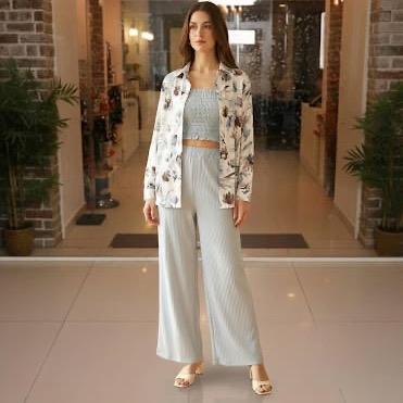 Model in a soft blue pleated coord set with printed overlay jacket